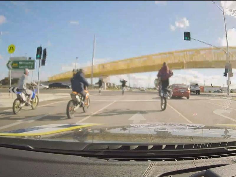 Dashcam footage of unregistered trail bike riders doing wheelies through traffic in Melbourne. 