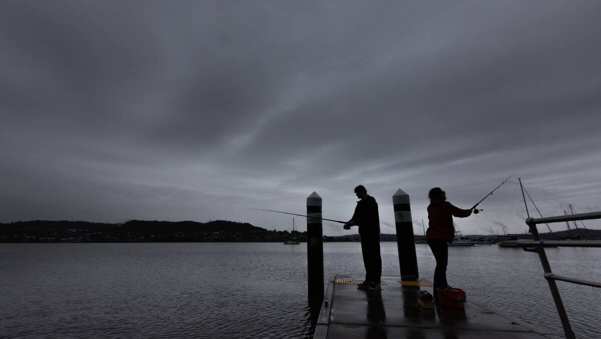 Joe Finchey fishing with his mum Jess Cox on a gloomy Sunday. Picture by Jonathan Carroll