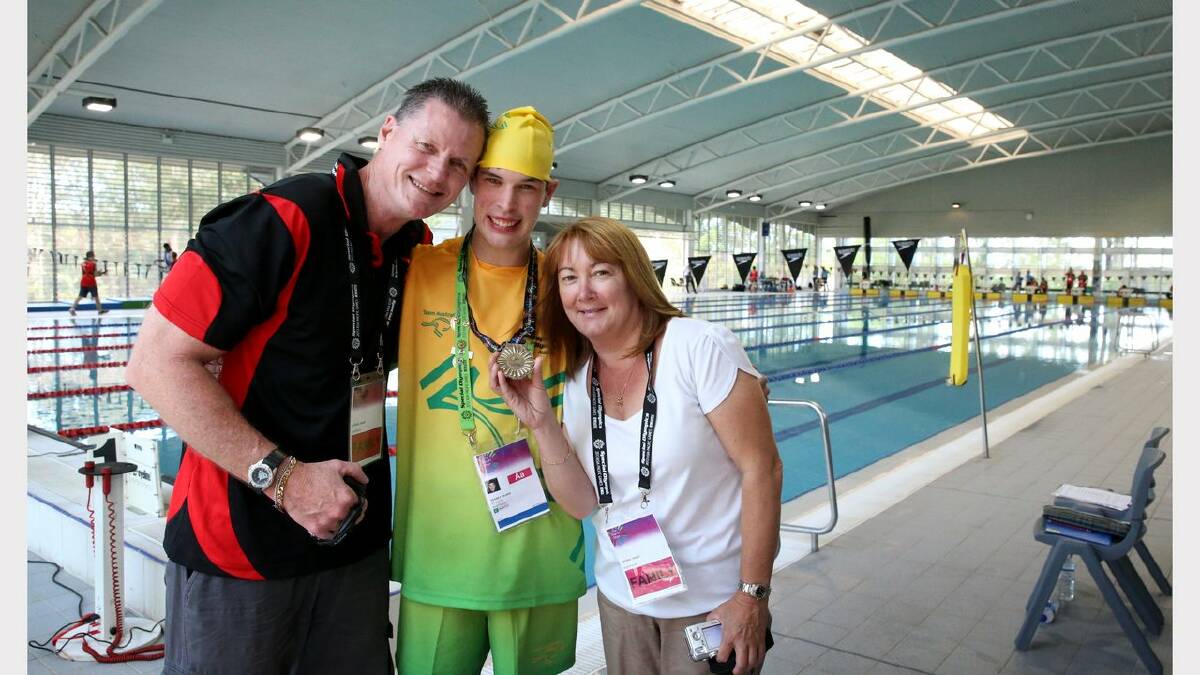 Scenes from the Special Olympics swimming at The Forum pool. Blake Veaney won a gold medal in the 25 meter backstroke, with his Mum and Dad Rick Veaney and Anthea Veaney of WA. Picture: Dean Osland. 