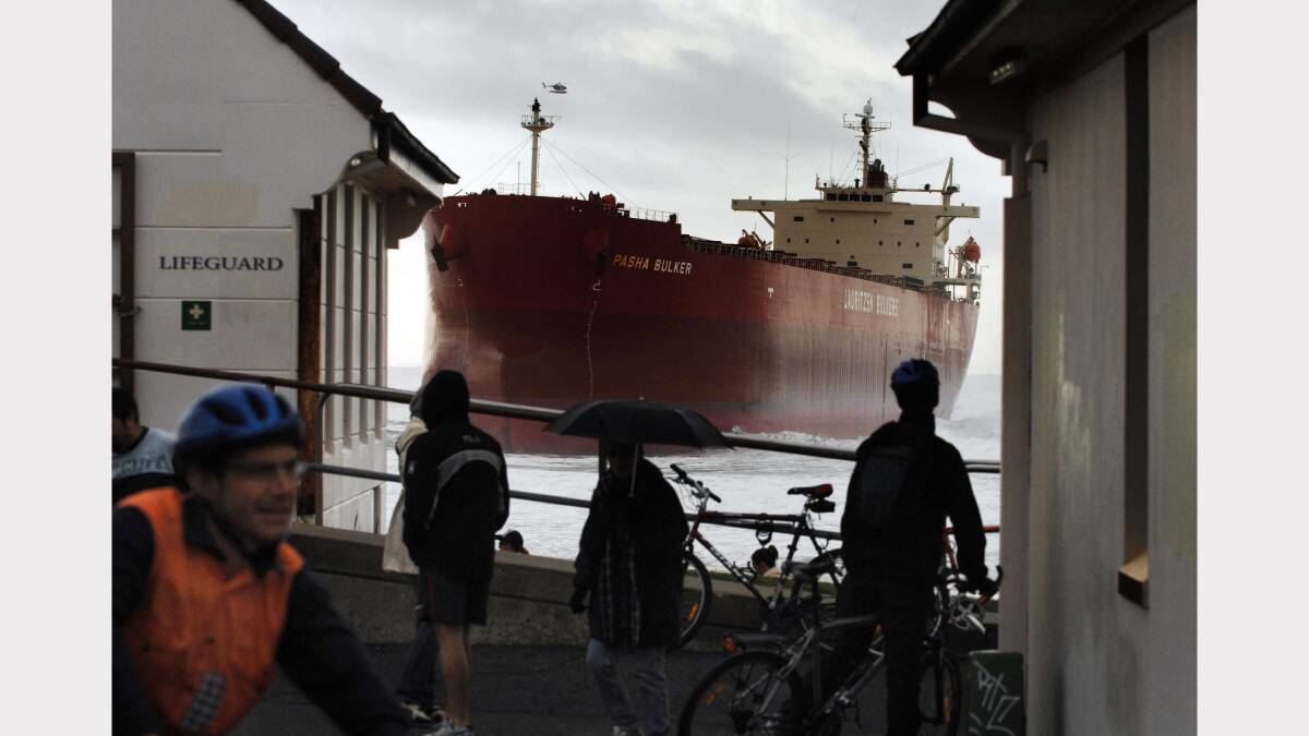 2007 file photo of sightseers gathering to see the 225-metre coal carrier Pasha Bulker wedged on a sand bar off Nobbys Beach, Newcastle. The master of the Pasha Bulker was largely to blame for the bulk carrier running aground on a Newcastle beach, an investigation by the Australian Transport Safety Bureau found Friday, May 23, 2008. Credit: AAP Image/Dean Lewins