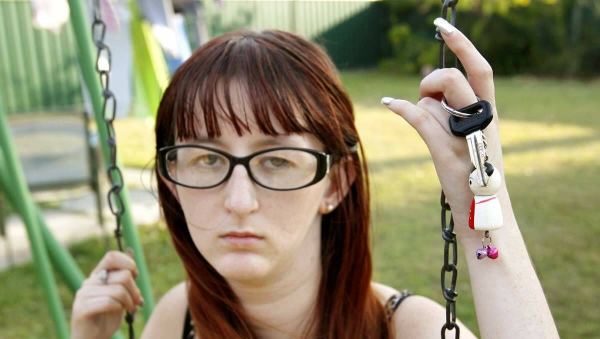 ANGRY: Amber Houlihan  with all that’s  left of her car – the key.    Picture: Max Mason-Hubers